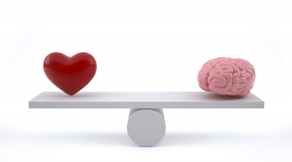 Brain and heart on a balance scale